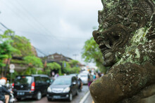 Balinese Demon God Statue With Traffic In The Background, Ubud Bali