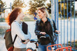 © Cavan Images - Two young student talking at the park together