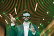 © Westend61 - Happy businessman wearing virtual reality simulator gesturing in office
