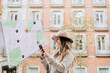 © Westend61 - Woman navigating location with smart phone in front of building