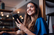 © Westend61 - Happy businesswoman with smart phone at office
