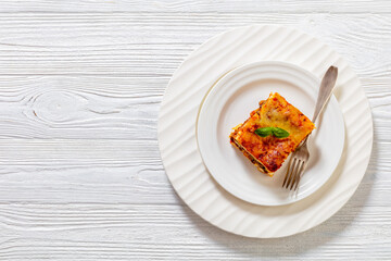 Wall Mural - portion of Lasagna on white plate, top view