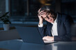 © Westend61 - Frustrated businessman with head in hand watching laptop at office