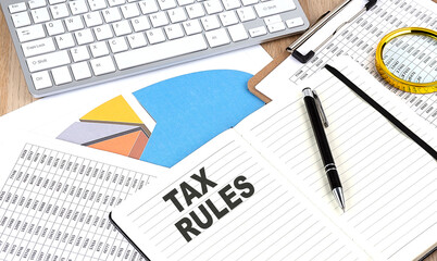 Aufkleber - TAX RULES text on a paper on chart background