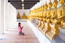 Asian Woman To Pay Respect To Buddha Statue In Thailand.
