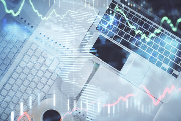 Poster - Financial market graph and top view computer on the desktop background. Multi exposure. Investment concept.