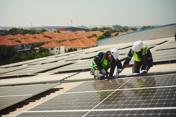 Two male engineer install solar panels.