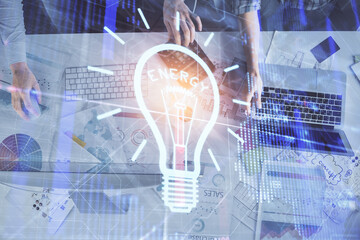 Poster - Double exposure of man and woman working together and light bulb hologram drawing. Idea concept. Computer background.