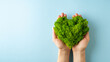 World earth day concept with green plant heart on blue background,