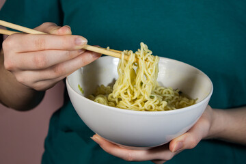 Sticker - Hands take noodles with chopsticks for food. Boiled instant noodles