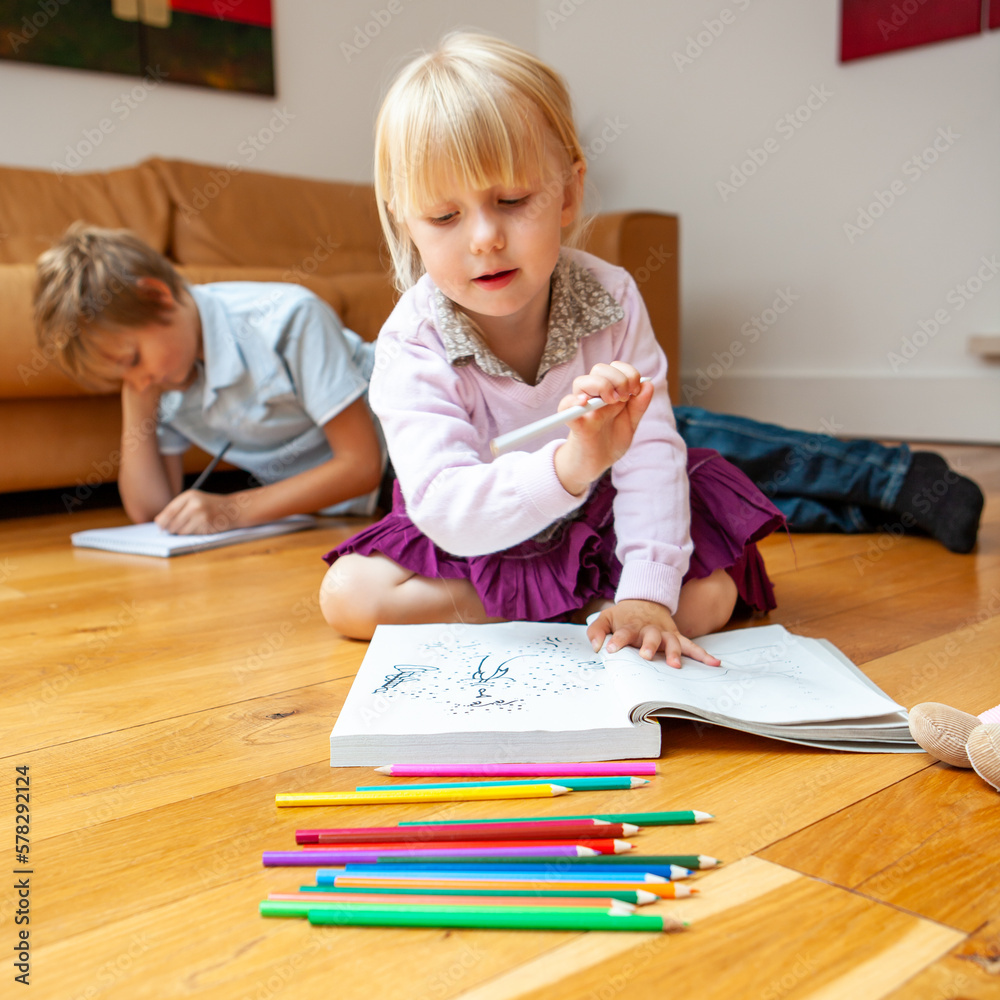 Family Life, Creative Fun. A preschool girl enjoying coloring and ...