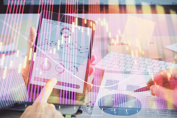 Poster - Multi exposure of man's hands holding and using a phone and financial chart drawing. Market analysis concept.