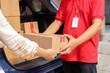 © Queenmoonlite Studio - Cropped shot of delivery courier giving package to customer. Man delivering packages. Logistic concept.