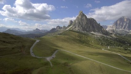 Wall Mural - Aerial footage of beautiful dolomites landscape. Mountain scene of meadows and high alps and mountain road with many curves.