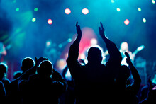 Audience And Fans Enjoy Live Music On A Concert With Blurry Bokeh Background
