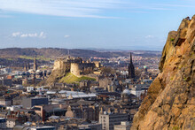 Edinburgh Castle Bathed In Spring Sun With Salisbury Crags On Right