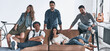 © gstockstudio - Group of modern young people looking at camera and smiling while relaxing at home