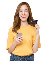 Wall Mural - Cheerful beautiful Asian woman holding smartphone and mockup credit card on orange background.