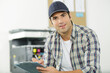 © auremar - smiling repairman standing with his clipboard