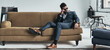 © gstockstudio - Handsome young man in nice suit adjusting his sunglasses while relaxing on the couch