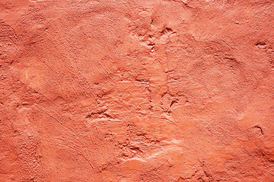 Wall Mural -  - Coral orange red abstract grunge texture background for design. Painted old damaged rough wall surface. Close-up.