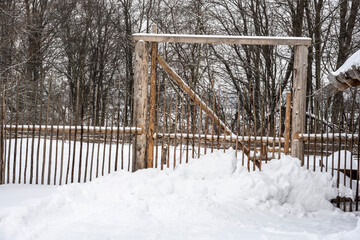 Wall Mural - old houses and household buildings made of wooden beams according to old technologies in the vicinity of Veliky Novgorod in winter