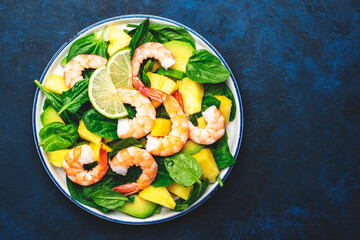 Wall Mural - Fresh pineapple salad with shrimps, spinach, avocado and lime on blue table, top view. Healthy eating, balanced, clean diet food