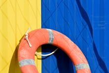 Yellow And Blue Container And Orange Lifebuoy

