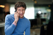 © A.B./peopleimages.com - Im listening...a businessman using his cellphone at work in an office.
