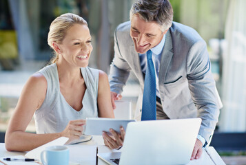 Poster - Theyre a dynamite corporate couple. two mature businesspeople talking together of a tablet and laptop.