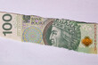 Polish 100 Złotych banknote in torn paper hole