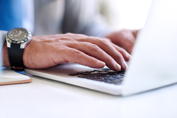 Wall Mural - Making success happen. Closeup shot of an unrecognizable businessman using a laptop outdoors.