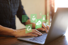 Reduce CO2 Emission Concept. Businessman Use Laptop Computer With Environment Icon. Technology Net Zero And Carbon Neutrality, Green Business And Development Based On Renewable Energy. Climate Change,