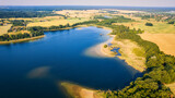 Fototapeta Las - This stunning drone panorama captures a lake in Poland's Lubuskie Voivodeship on a bright and sunny spring day