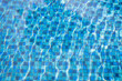 Clear swimming pool with blue ceramic tiles for background.