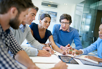 Aufkleber - Putting their ideas on the table. A group of businesspeople discussing work using a digital tablet in a boardroom meeting.