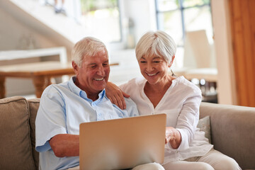 Wall Mural - Its so much easier to watch movies on the laptop. a senior couple using a laptop together.