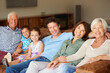 Carefree time as one big, happy family. a happy multi-generational family sitting together on a sofa.