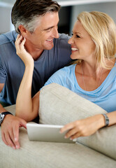 Poster - Theres nowhere Id rather be. an affectionate mature couple using a digital tablet while sitting on their sofa at home.