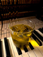 A Glass Of Bourbon On A Piano Keyboard