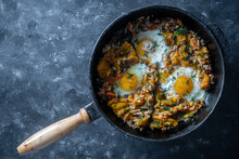 Boiled Rice With Fried Eggs, Pumpkin, Peppers, Carrots And Onions In A Cast Iron Pan, Closeup. Food Background. Healthy Food