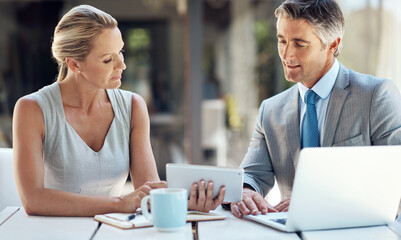 Aufkleber - Take a look at this. a mature business couple viewing work together in the office on a tablet to plan their next move.