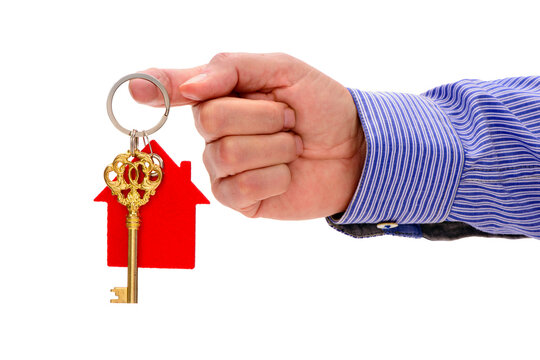 Fototapete - isolated home key in hand over transparent background