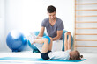 © Photographee.eu - Professional physician explain to child how to perform an exercise