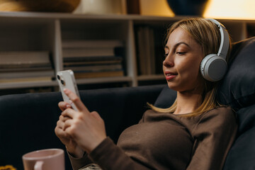 Young caucasian woman is using her mobile phone