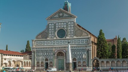 Sticker - Basilica of Santa Maria Novella in the homonym square timelapse in Florence. Flowerbeds and green grass in front of it. People sitting on a bench. Blue sky at summer day