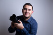 © Arvin - fotógrafo profesional con su cámara sonriente frente a un fondo blanco