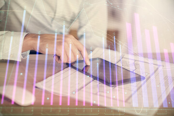 Aufkleber - Double exposure of man's hands holding and using a digital device and forex graph drawing. Financial market concept.