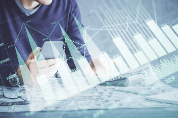 Wall Mural - Double exposure of man's hands holding and using a digital device and forex graph drawing. Financial market concept.