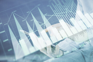 Aufkleber - Double exposure of man's hands holding and using a digital device and forex graph drawing. Financial market concept.